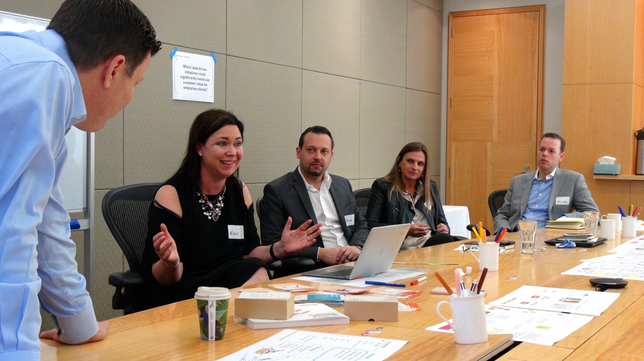 Nicole Sheffield speaking with News Corp Australia workshop participants around a table of working materials