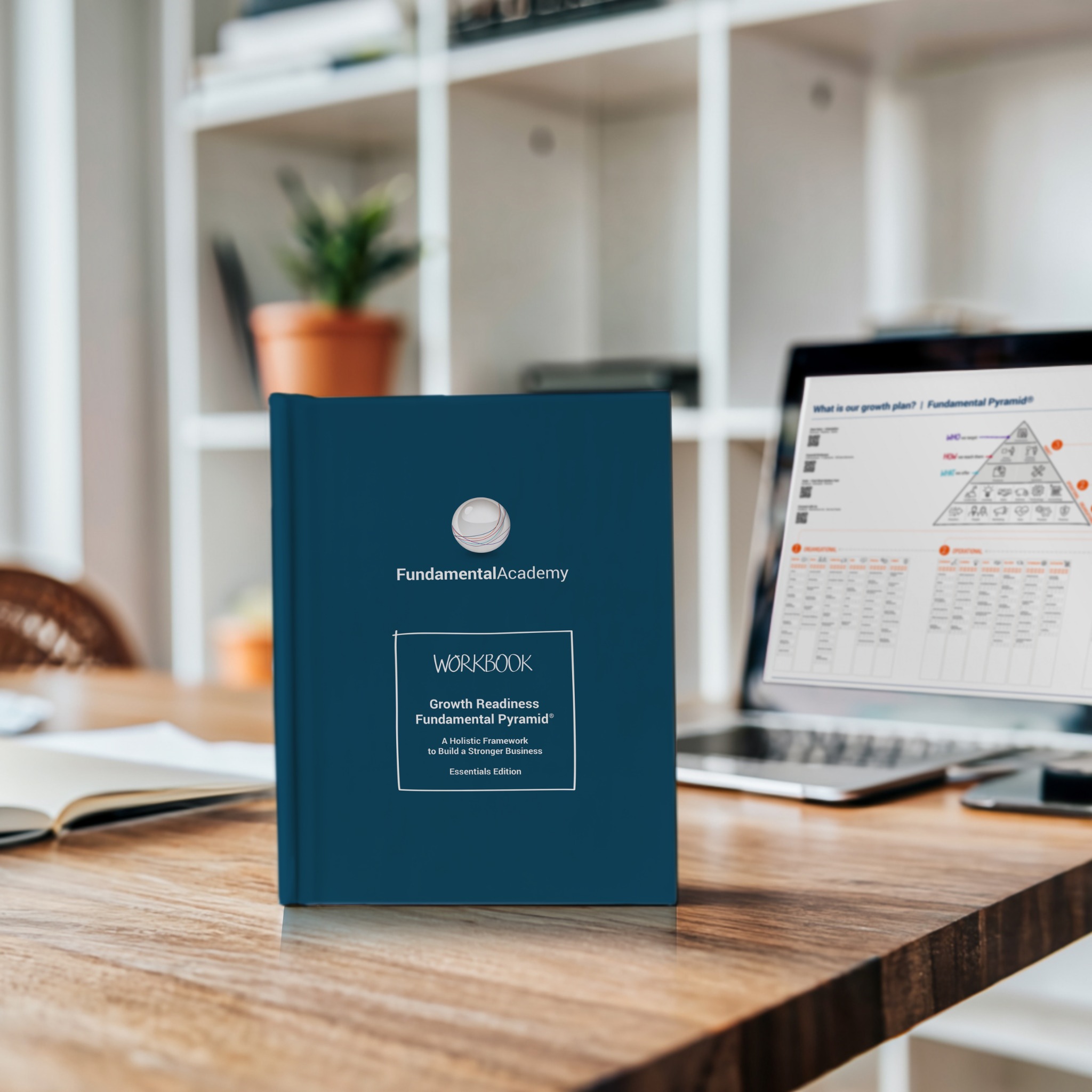 Fundamental Academy workbook and Fundamental Pyramid on a laptop